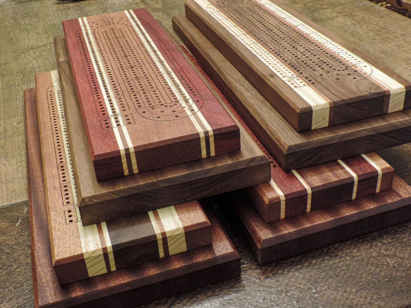 Canadian Made 3-lane 2-tier Cribbage boards ontop of a harvest tabe | Bergeron Woodgrains