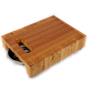 Raised Cherry hardwood end grain cutting board prep station with built-in waste cutout and 2 stainless steel bowls on a track beneath.