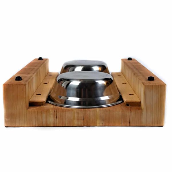 Raised Cherry hardwood end grain cutting board prep station with built-in waste cutout and 2 stainless steel bowls on a track beneath.