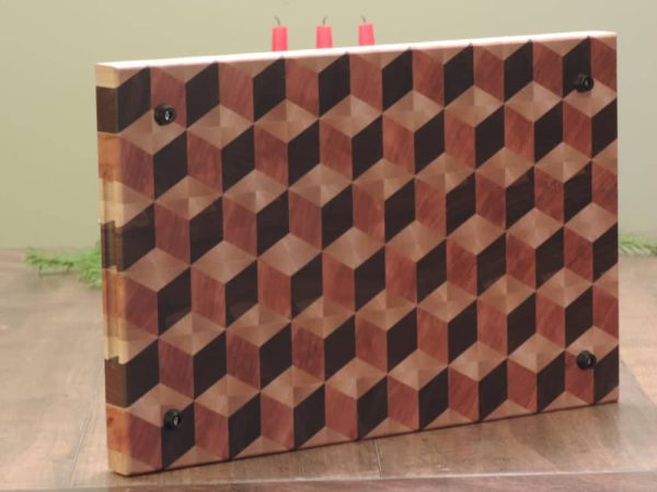 Handcrafted 12x18" 3D tumbling block end grain cutting board featuring embedded grooved handles along the side of the cutting board. Canadian made by Bergeron Woodgrains