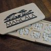 Handcrafted Mancala board game using Canadian Maple, authentic stone pieces and embedded magnetic closures. Convenient design and compact storage, made by Bergeron Woodgrains.