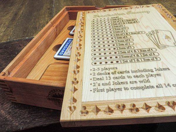 Handcrafted wooden board game featuring a Frustration Rummy scorecard with storage box with metal peg storage and Bicycle playing cards displayed. Made by Bergeron Woodgrains