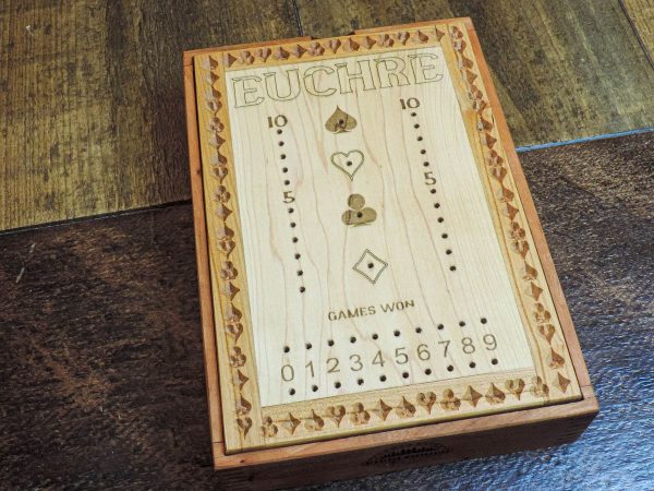 Handcrafted wooden board game featuring a Euchre scorecard with peg and playing card storage box showcasing dovetail and box finger joints. Made by Bergeron Woodgrains