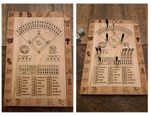 Handcrafted wooden board game featuring a Dice Baseball scorecard with storage box for accessories. Next to it a Dice Baseball wood score card with metal pegs and dice displayed.