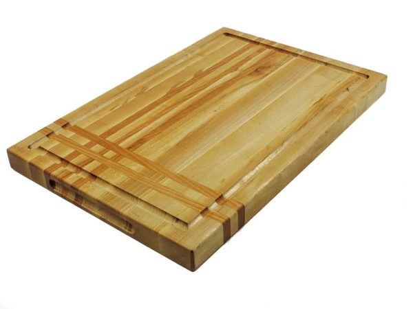 Maple edge grain cutting board with cherry stripes along the long and short edge. Showcasing a juice groove and handles. Canadian made by Bergeron Woodgrains