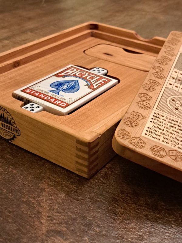 Handcrafted wooden board game featuring a Ludo scorecard with storage box with peg storage and Bicycle playing cards displayed. Played similar to Parcheesi. Made by Bergeron Woodgrains