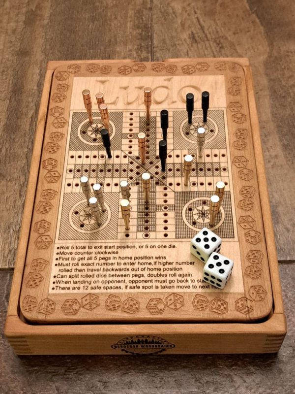 Handcrafted wooden board game featuring a Ludo scorecard with storage box displaying pegs and dice in play. Played similarly to Parcheesi. Made by Bergeron Woodgrains