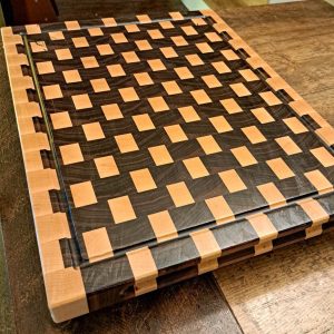 Maple and walnut checkered basket weave end grain cutting board butcher block measuring 18”x24’x1.5”. Showcasing juice groove and handles. Canadian made by Bergeron Woodgrains