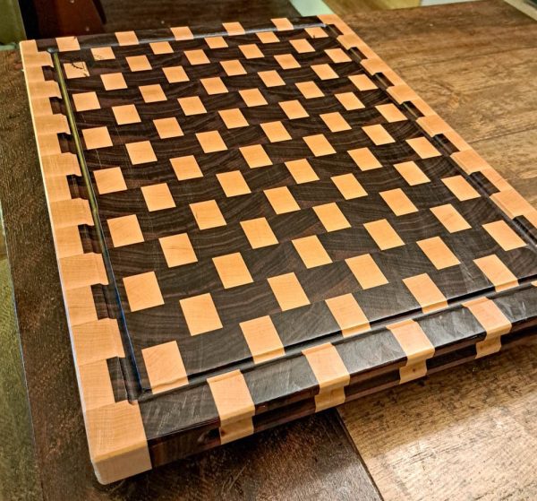 Maple and walnut checkered basket weave end grain cutting board butcher block measuring 18”x24’x1.5”. Showcasing juice groove and handles. Canadian made by Bergeron Woodgrains