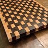 Maple and walnut checkered basket weave end grain cutting board butcher block measuring 18”x24’x1.5”. Showcasing handles along the side. Canadian made by Bergeron Woodgrains