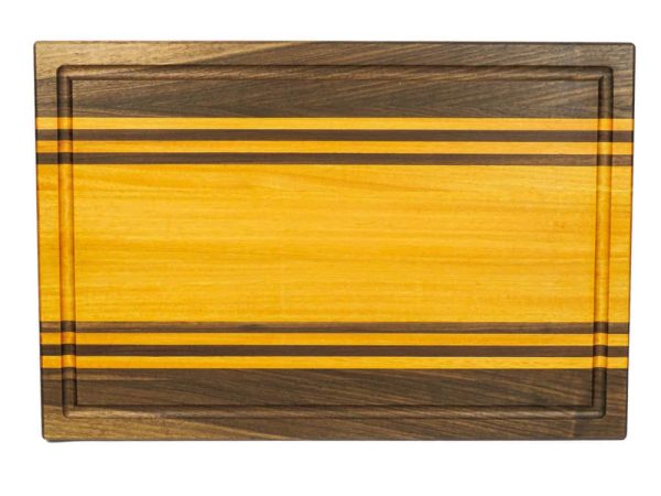 Walnut and Osage Orange edge grain cutting board with walnut and osage orange accent strips showcasing juice groove. Made in Canada by Bergeron Woodgrains