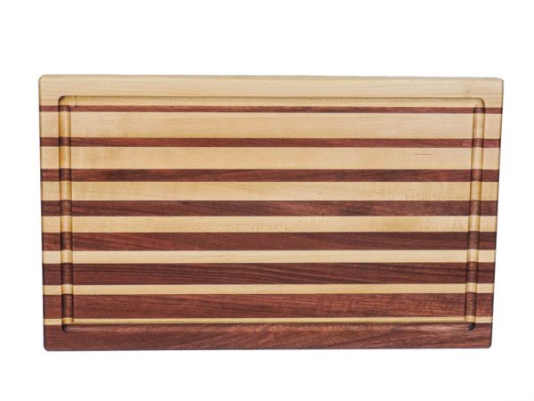 Maple and purple heart edge grain cutting board featuring narrowing opposing strips running along the long edge of the cutting board with juice groove. Canadian made by Bergeron Woodgrains