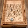 Handcrafted wooden board game featuring a Serpents and Ladders scorecard with storage box displaying pegs and dice in play. Played similarly to Snakes and Ladders. Made by Bergeron Woodgrains