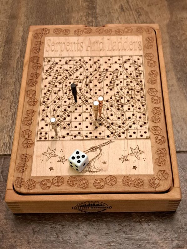 Handcrafted wooden board game featuring a Serpents and Ladders scorecard with storage box displaying pegs and dice in play. Played similarly to Snakes and Ladders. Made by Bergeron Woodgrains