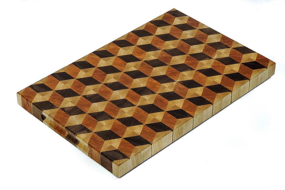 Handcrafted 12x18" 3D tumbling block end grain cutting board featuring embedded grooved handles along the side of the cutting board. Canadian made by Bergeron Woodgrains