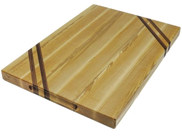 Maple edge grain cutting board with two walnut accent strips along 2 opposing corners. Featuring an embedded grooved handle on the side of the cutting board. Made in Canada by Bergeron Woodgrains