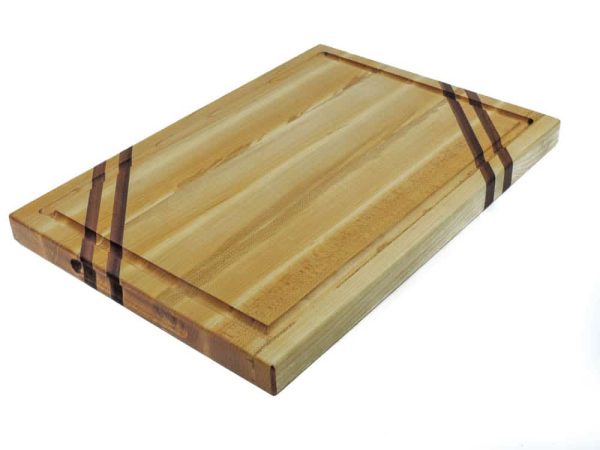 Maple edge grain cutting board with two walnut accent strips along 2 opposing corners. Featuring a juice groove on the face of the cutting boardand handles along the side. Made in Canada by Bergeron Woodgrains