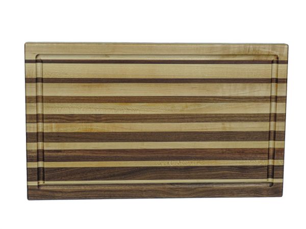 Maple and walnut edge grain cutting board featuring narrowing opposing strips running along the long edge of the cutting board and a juice groove on the face of the cutting board. Canadian made by Bergeron Woodgrains