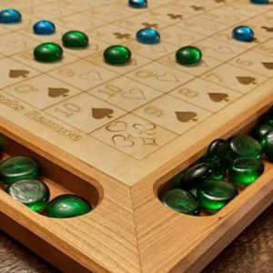 Handcrafted wood sequence board game featuring a cherry border with game piece cutouts and laser engraved baltic birch centre and walnut miter keys on each corner. Canadian made by Bergeron Bergeron