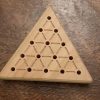 Wood triangle peg solitaire brain teaser game featuring guidelines for legal moves, bevelled edges and scoring instructions on the back. Made in Canada by Bergeron Woodgrains