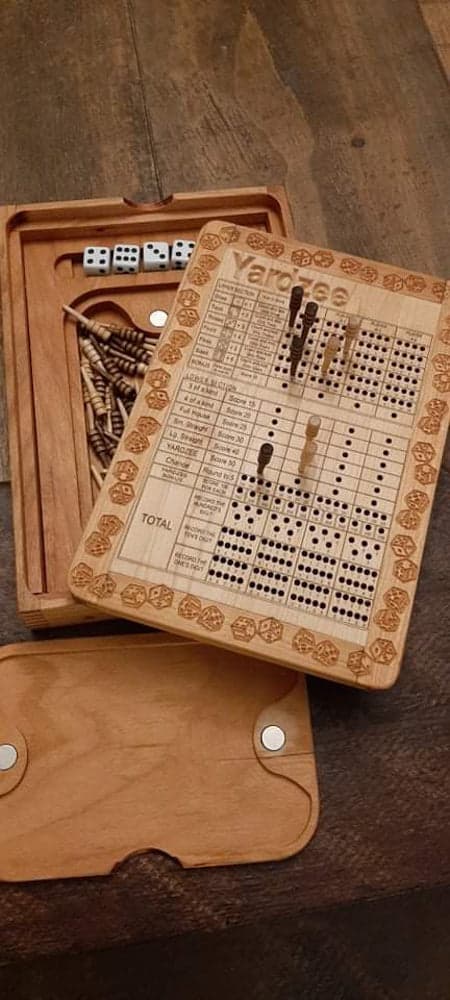 Handcrafted wooden board game featuring a Yardzeee scorecard with storage box for game accessories. Yahtzee Game scorecard, Pegs and magnetic peg closure are featured. Made by Bergeron Woodgrains.