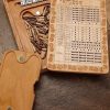 Handcrafted wooden board game featuring a Yardzee and Dice Connect 4 with storage box for accessories. Scorecards with pegs, dice and magnetic peg closure are displayed. Made by Bergeron Woodgrains.