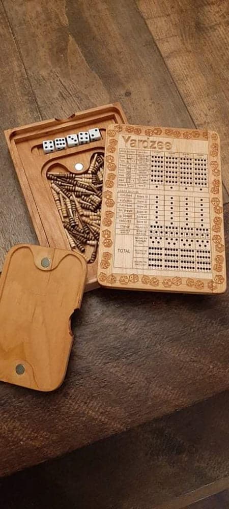 Handcrafted wooden board game featuring a Yardzee and Dice Connect 4 with storage box for accessories. Scorecards with pegs, dice and magnetic peg closure are displayed. Made by Bergeron Woodgrains.