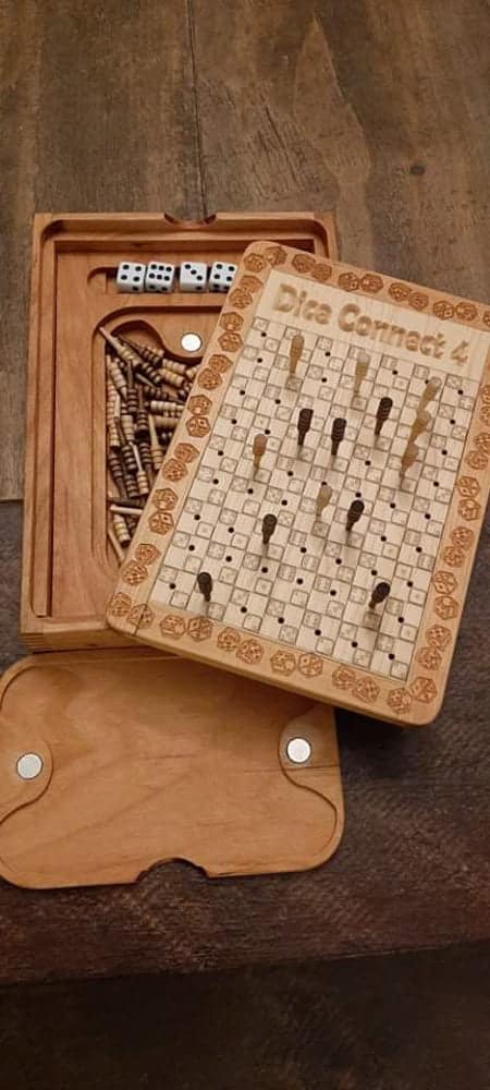 Handcrafted wooden board game featuring a Dice Connect 4 scorecard with storage box for game accessories. Game scorecard, Pegs and magnetic peg closure are featured. Made by Bergeron Woodgrains.