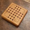 Wood square traditional peg solitaire brain teaser featuring guidelines for legal moves, bevelled edges and scoring instructions on the back. Made in Canada by Bergeron Woodgrains