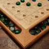 Handcrafted wood sequence board game featuring a cherry border with game piece cutouts and laser engraved baltic birch centre and walnut miter keys on each corner. Canadian made by Bergeron Bergeron