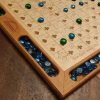 Handcrafted wood sequence board game featuring a cherry border with game piece cutouts and laser engraved baltic birch centre and walnut miter keys on each corner. Canadian made by Bergeron Bergeron