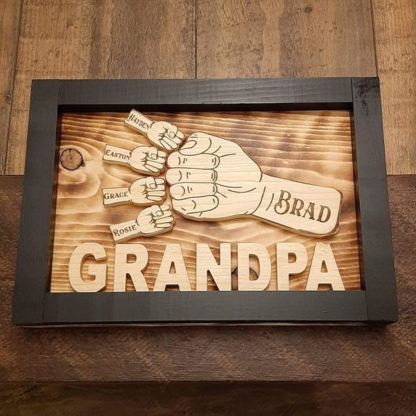 Handcrafted wooden home decor sign made by Bergeron Woodgrains. Black painted frame with natural wood name label such as Grandpa with matching big fist bump surrounded by smaller fist bumps with matching children’s names all on a flame torched wood background.