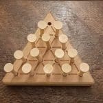 Wood triangle peg solitaire brain teaser featuring guidelines for legal moves, bevelled edges, wooden pegs and scoring instructions on the back. Made in Canada by Bergeron Woodgrains