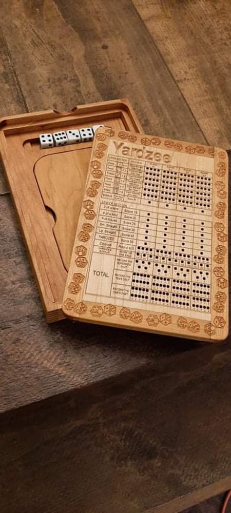 Handcrafted wooden board game featuring a Yardzee scorecard with storage box for accessories, similar to Yahtzee. Made by Bergeron Woodgrains.