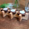 Tealight centrepiece with Maple and walnut accents set upon a harvest table with house plant home decor