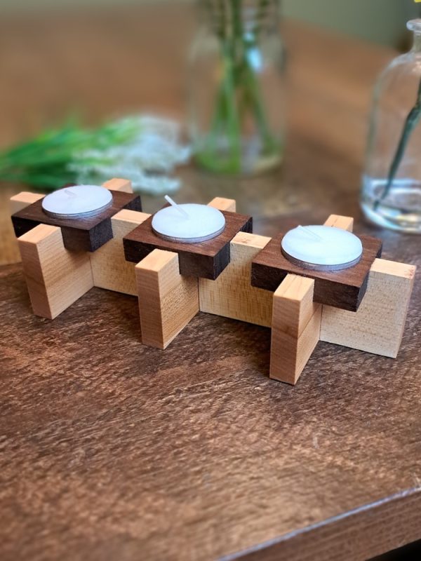 Tealight centrepiece with Maple and walnut accents set upon a harvest table with house plant home decor