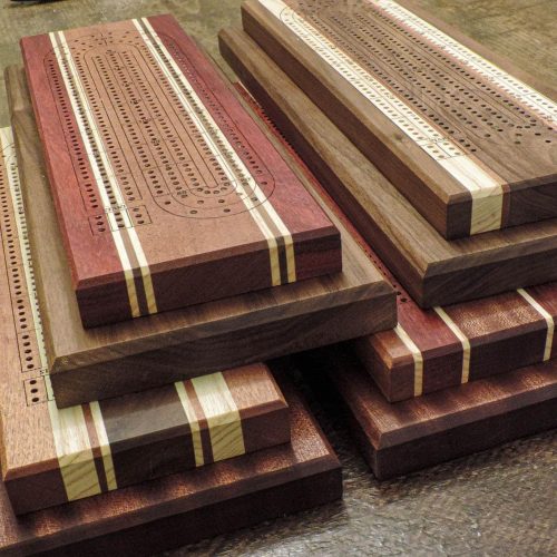 Canadian Made 3-lane 2-tier Cribbage boards ontop of a harvest tabe | Bergeron Woodgrains