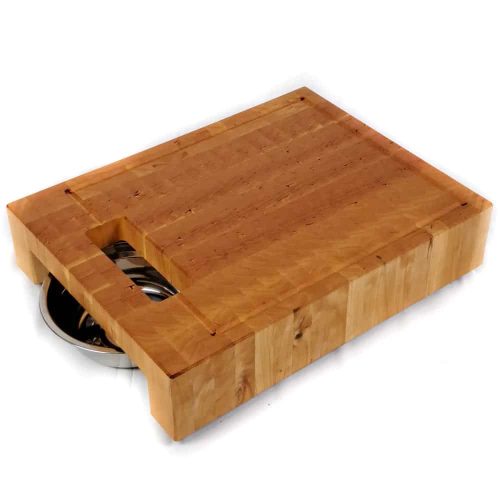 Cherry end grain cutting board with built-in waste cutout and 2 stainless steel bowls on a track beneath.
