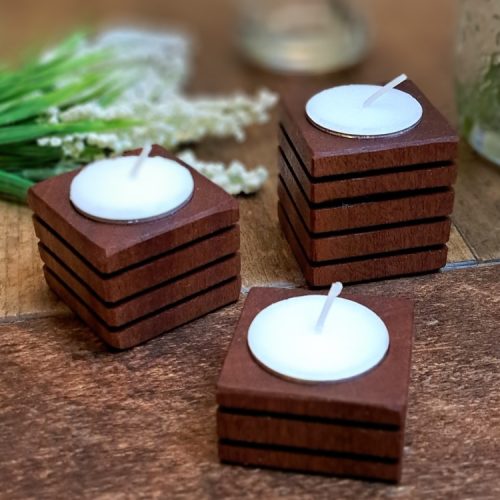 Set of 3 tealight candle holder placed on a wooden harvest table with plants set around them. Made in Canada by Bergeron Woodgrains